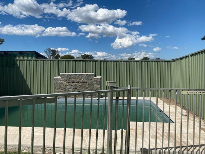 Colorbond fence extension beside a Sydney pool